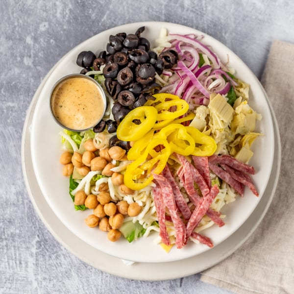 Pacioni's Pizzeria Italian salad with olives, pepperoni, chickpeas, peppers, onions, and dressing.