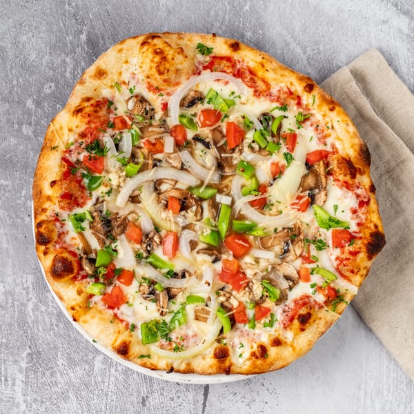 Pacioni's Pizzeria's vegetarian pizza with mushrooms, onions, green peppers, and tomatoes.